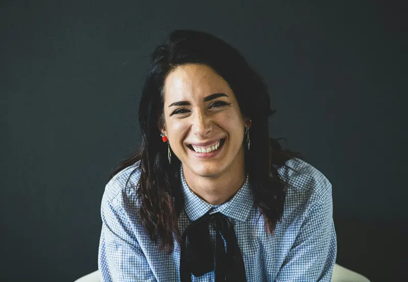 Lina Cortez working at her desk during a coaching session