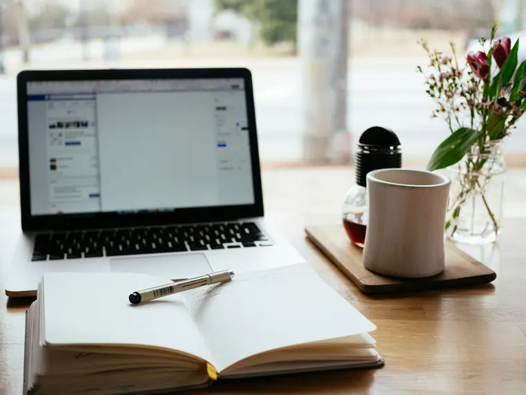 Notebook and coffee on a desk, ready for a focused planning session