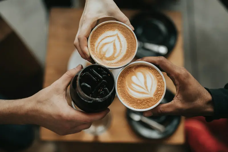 Friends sharing drinks at Roastline