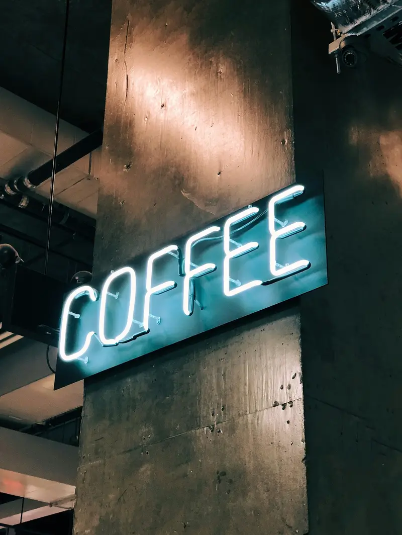 Neon "coffee" sign glowing in the café